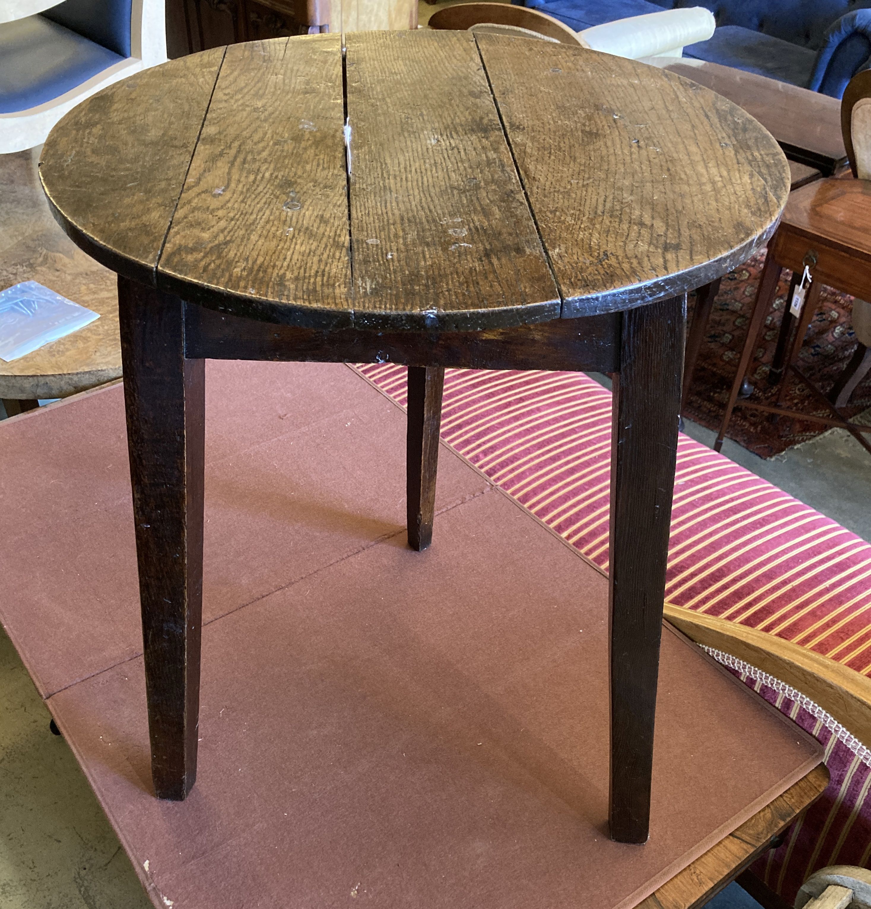 A 19th century circular oak cricket table, 55cm diameter, height 69cm